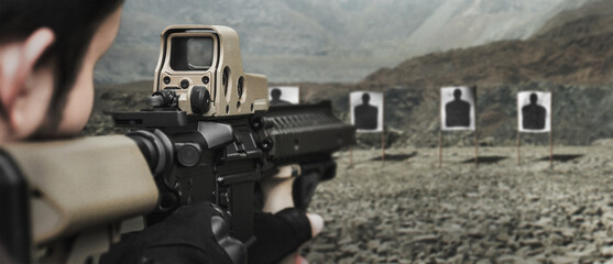 Military soldier shooter aiming assault rifle weapon at outdoor academy shooting range  - obrazy, fototapety, plakaty