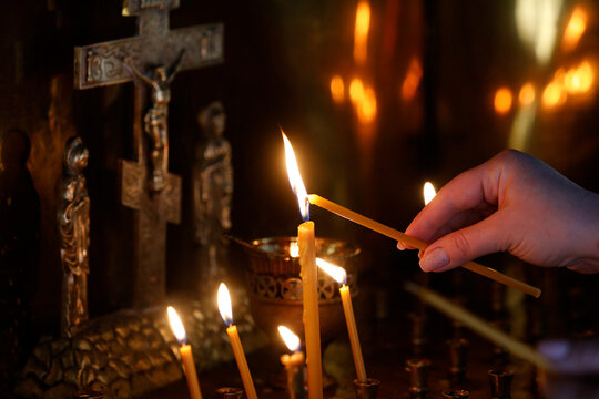Faithful lighting a candle in Saint Teaodor Tiron (Ciuflea) Cathedral and Monastery, Chisinau, Moldova