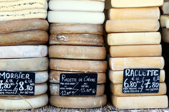 Traditional French cheese, Raclette and Morbier, mountain cheese for sale at market, France