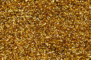 Gold glitter texture sparkling shiny background for Christmas card.  Twinkly golden  glitter lights...