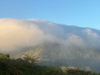 Fog covered the mountain top in the morning.