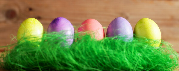 Row of colorful Easter eggs on wooden banner background