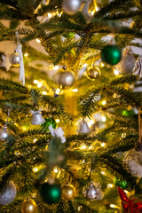 Decorated Christmas tree with balls and garland.