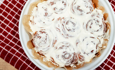 Freshly baked cinnamon rolls with cream cheese.