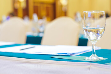 Drinkking water in wine glass on table of meeting room