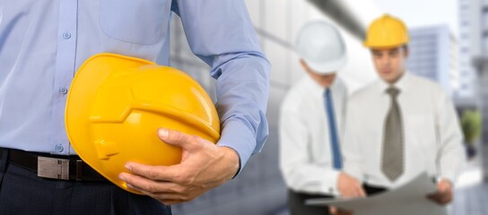 Businessman or architect hold safety helmet