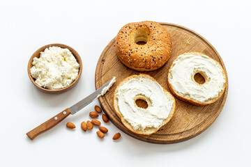 Homemade baked bread bagels with cheese cream. Healthy breakfast background