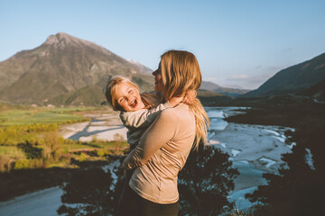 Mother walking with daughter family vacations together travel outdoor parent and child girl happy emotions mountains landscape - 694901900