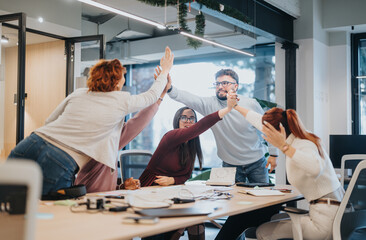 Successful team celebrates the achievement of a finished project.