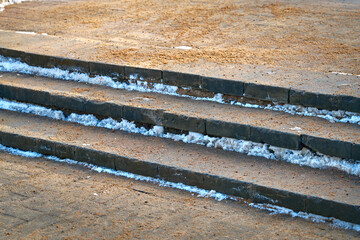 Sand sprinkled on stairs to prevent slipping on slick steps. Spread sand for more traction to...