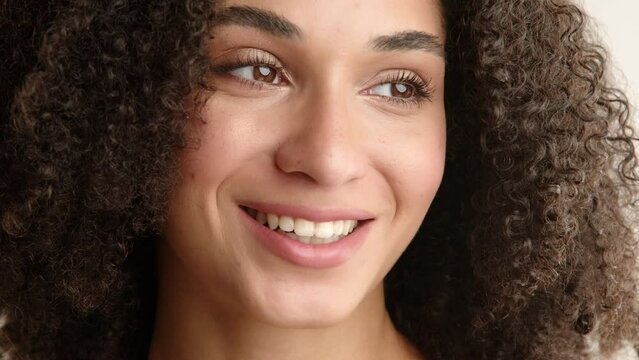 Portrait of happy cheerful woman with beautiful hazel eyes, full lips of natural color, white straight teeth, graceful facial features, posing, flirting. High quality 4k footage
