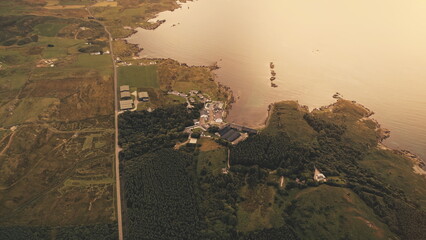 Top down whiskey distillery at sunset seascape. Aerial nobody nature landscape at sun set light....