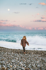 Child girl walking on beach sunset sea landscape kid 5 years old family vacations travel lifestyle summer holidays outdoor evening scenery