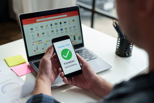 Entrepreneurs, businessmen use mobile phones to buy products through applications. View product and store details on your laptop. Payment successful Transactions in the office online service concept.