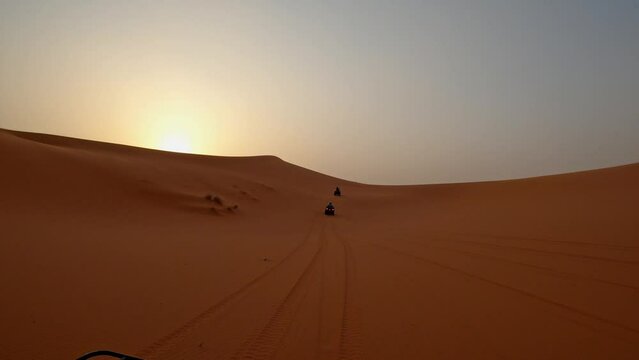 Quads on a sunset in the desert of Merzouga