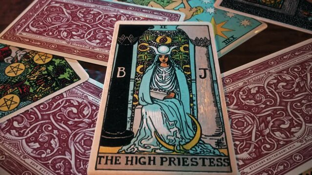 Lisbon, Portugal - January 1, 2022. Showing divination focus using The High Priestess card from a deck. Divination focus predicting future with tarot deck. Divination focus forecasting fortune. Deck.