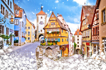 Cobbled street and architecture of historic town of Rothenburg ob der Tauber winter snow view