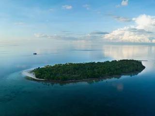 Foto op Canvas Early morning light illuminates the remote island of Koon near Seram, Indonesia. This scenic island's coral reefs, and the surrounding seas, support extraordinary marine biodiversity. © ead72