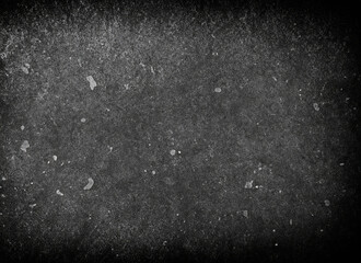 A textured, grainy, and dark surface with scattered light spots, Black grunge background