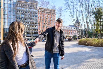 woman tugging on her partner's hand encouraging him to continue walking