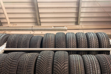 Car tires on rack in auto store. © BY-_-BY