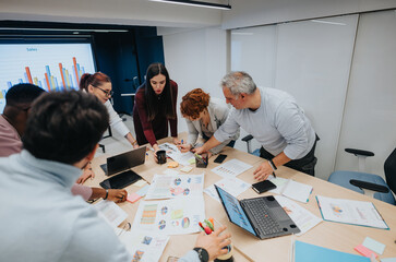 A diverse group of professionals in a business lecture collaborating and brainstorming ideas for strategic planning and profit growth.