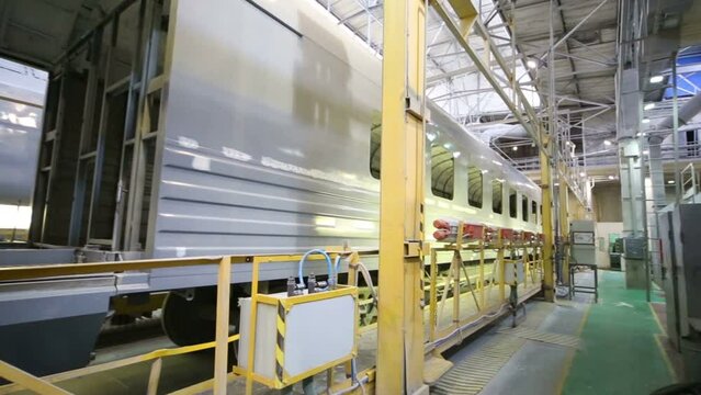 Body of unpainted wagon, side view in shop in Plant