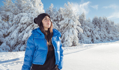 Beautiful woman with warm blue jacket walking in the winter mountain .Vitosha ,Bulgaria 