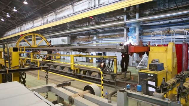 Two men doing weld in workshop in Tver Railway Carriage Plant