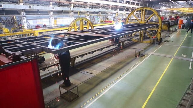 Two workers weld in Tver Railway Carriage Plant. 