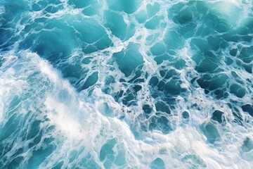 Stunning aerial top view background image of ocean sea water, white waves splashing in the deep sea.