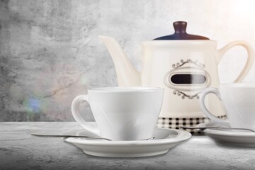 Hot tasty tea in cup and teapot