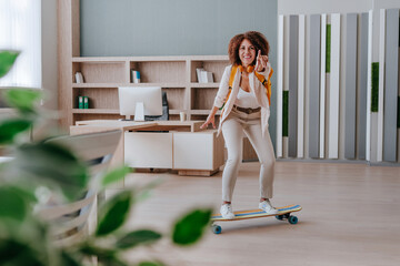 Elegant businesswoman in casual clothes riding on skateboard