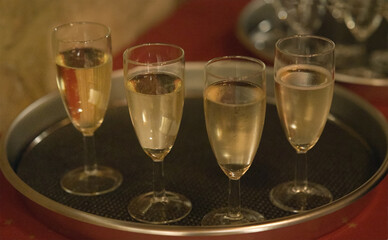 Four champagne glasses on a tray