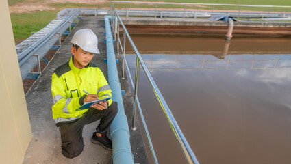 Fototapeta premium Environmental engineers work at wastewater treatment plants,Water supply engineering working at Water recycling plant for reuse