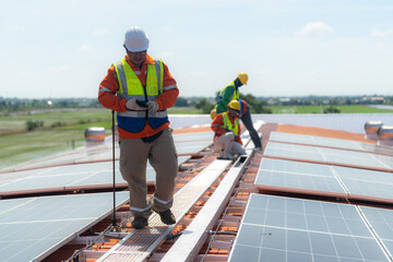 engineer men inspects construction of solar cell panel or photovoltaic cell by electronic device. Industrial Renewable energy of green power. factory worker working on tower roof.