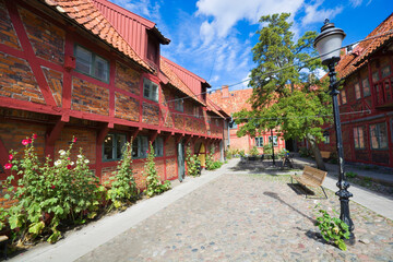 Lovely courtyard of half-timbered building of Helsa Farm in Ystad, Sweden - 694979138