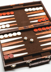 Backgammon suitcase game board with dice on a white table 