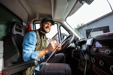 Young handsome man working in towing service and driving his truck.