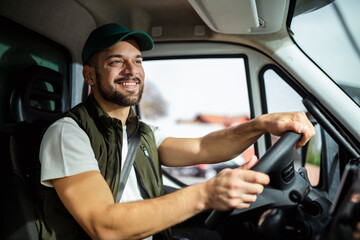 Young handsome man working in towing service and driving his truck.