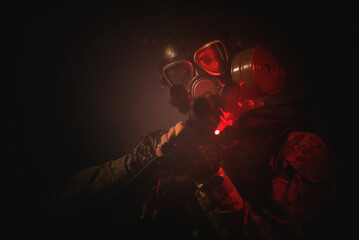 Post apocalypse soldier in a gas mask with a gun concept.