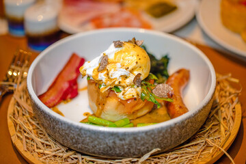 Elegant brunch dish with poached egg and fresh vegetables. Gourmet food presentation.