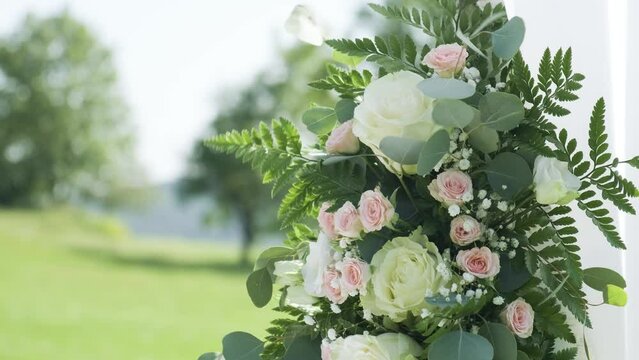 A beautiful garden flowers, adorned with blooming roses and lush greenery, perfect for a romantic outdoor wedding ceremony.