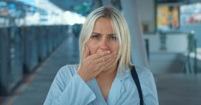 Shocked woman takes off glasses, covers mouth with hand. Expressive emotional stunned dazed appalled woman opens mouth in shock, covers in disgust, looks around in incomprehension and bewilderment