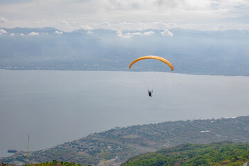 Paragliding soars at salena peak, palu city, Central sulawesi.