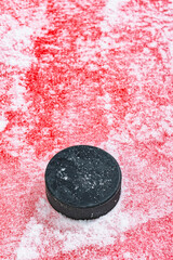 Looking down on an ice hockey puck at the red line
