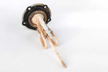 heating element of an electric hot water boiler with scum and sediment, on an isolated background