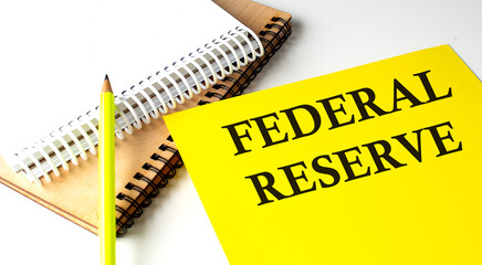 FEDERAL RESERVE text written on a yellow paper with notebook