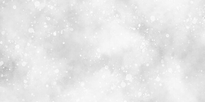 Winter snowfall in the winter season with particles, sunshine or sparkling lights and glittering glow winter morning of snow falling background, abstract bokeh glitter background on blurred blue.