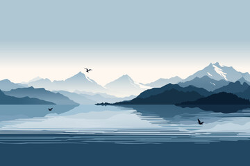 Landscape of beautiful mountains in blue tones in the fog and a picturesque reflection in the lake against the backdrop of sunset. Silhouettes of amazing mountains on the lake.